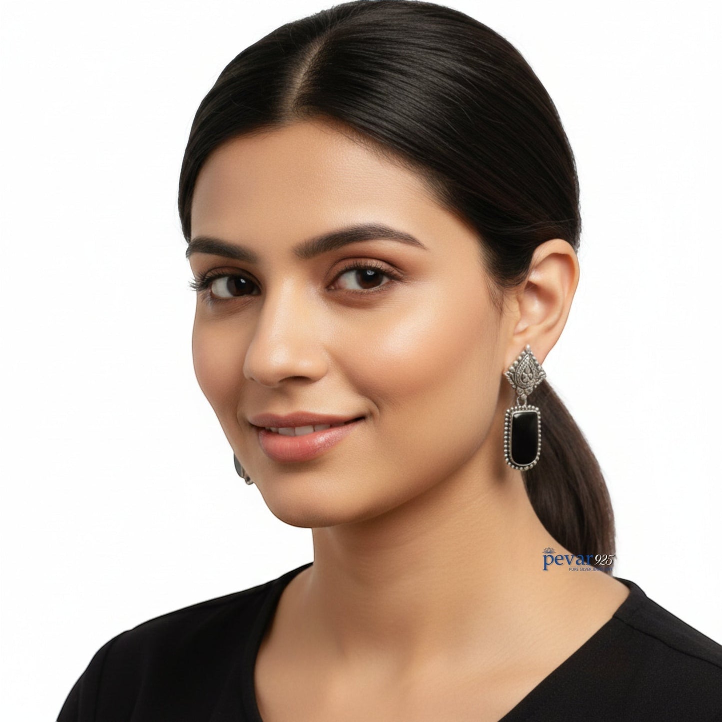 Woman wearing pevar925 oxidized 925 sterling silver drop earrings with black stones and intricate antique detailing