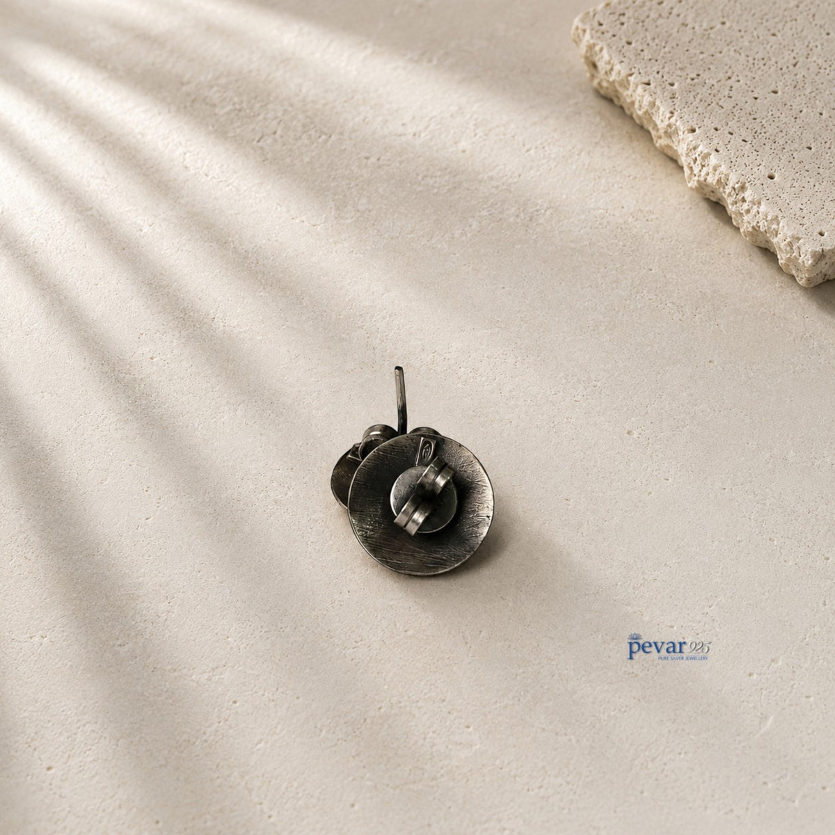 pevar925 oxidized 925 sterling silver disc stud earrings with push-back clasps on a textured stone surface