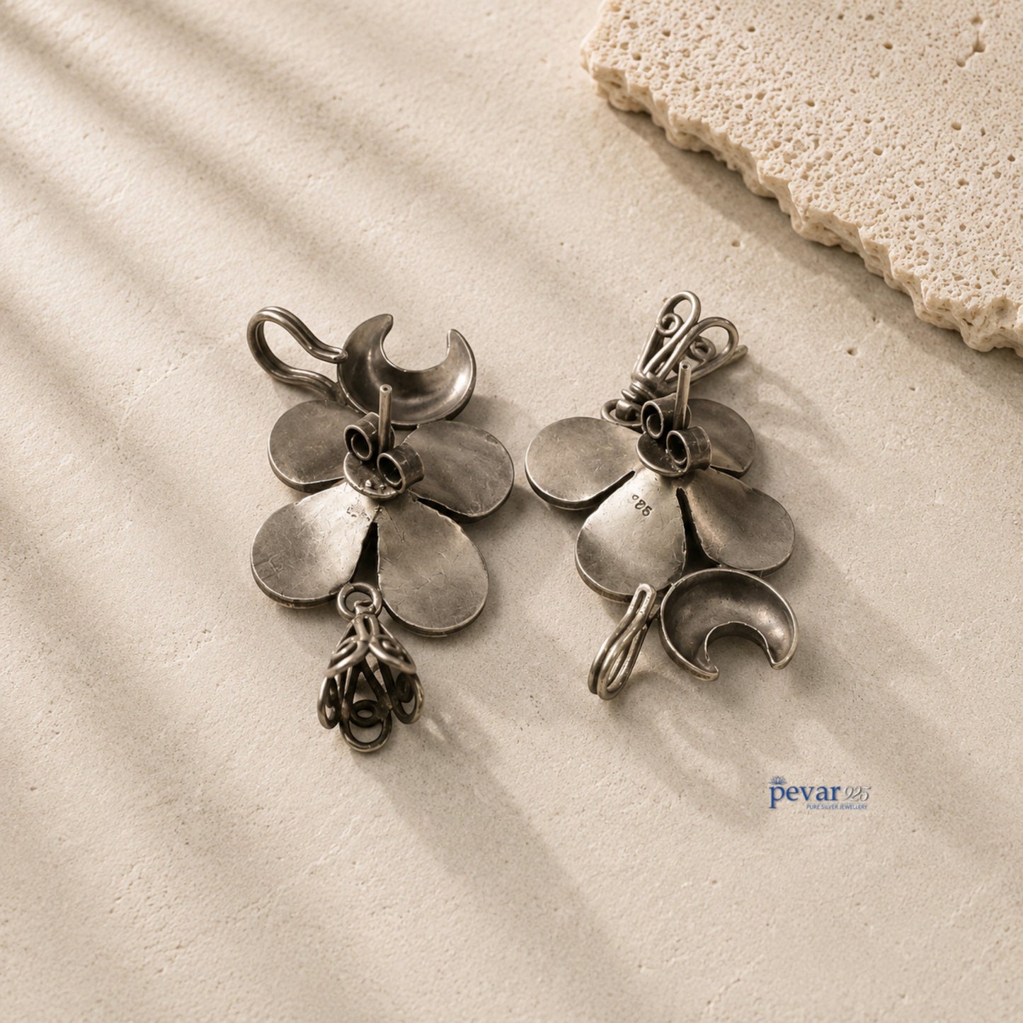 pevar925 oxidized 925 silver ear cuffs featuring crescent moon, flower motifs, and small dangling jhumkis.