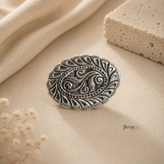 pevar925 oxidized silver oval ring featuring intricate leaf motifs and traditional chitai engraving on a beige background