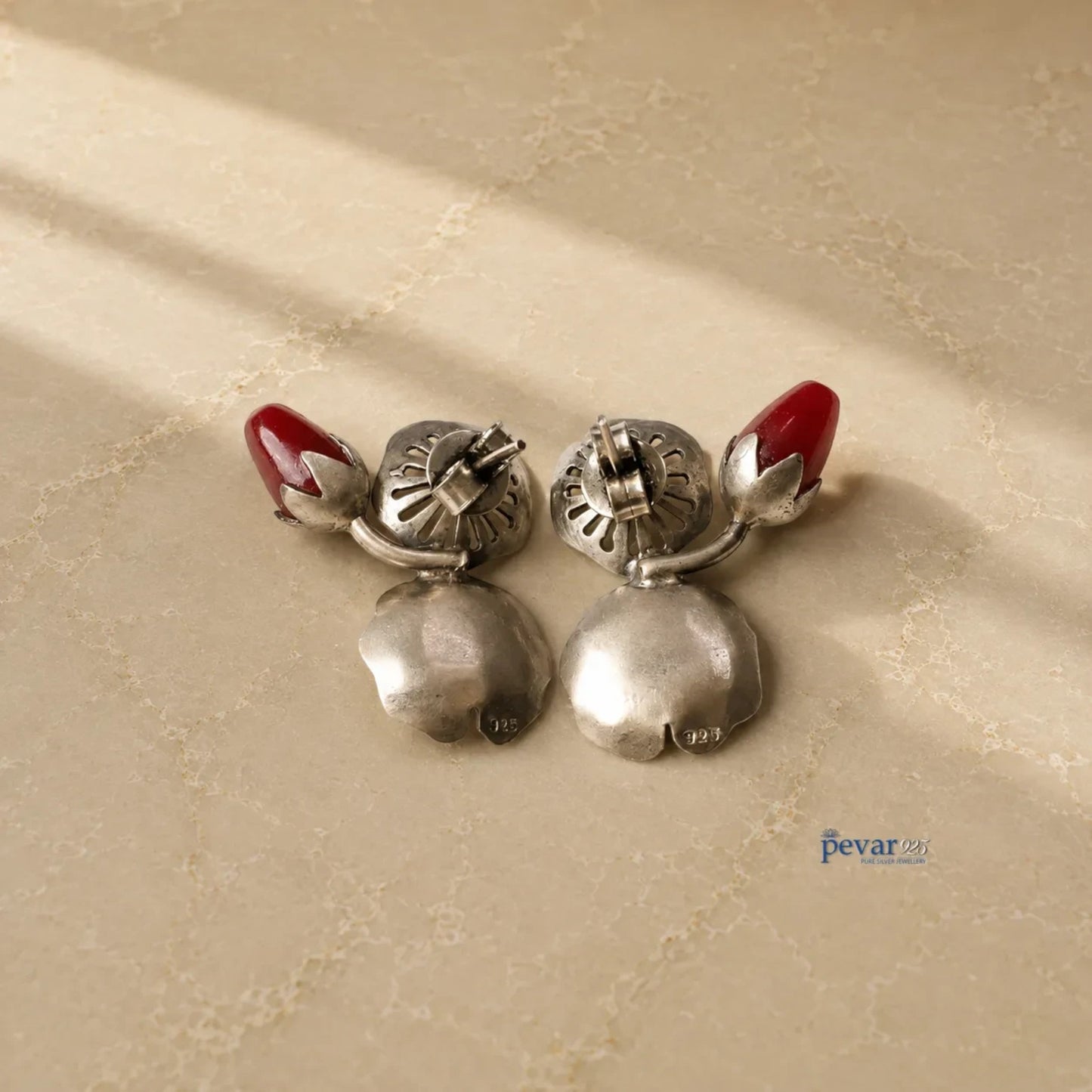 pevar925 oxidized 925 silver lotus earrings with red bead accents, showing the back view with hallmark stamps.