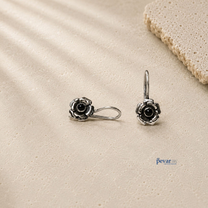 pevar925 oxidized 925 silver drop earrings featuring rose flower motifs with central black stones on a textured surface