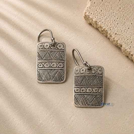 pevar925 oxidized 925 silver square hook earrings with geometric tribal patterns on a textured stone surface