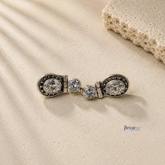 pevar925 oxidized 925 silver hook earrings featuring sparkling round stones on a textured stone surface