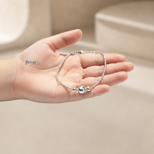 pevar925 sterling silver kids charm bracelet with three polished beads held in a child's hand