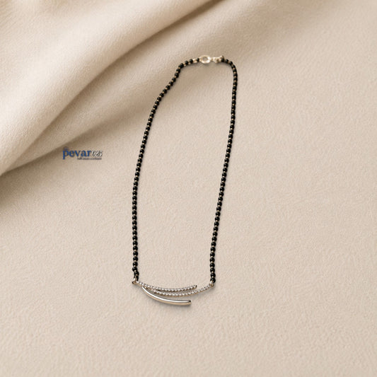 pevar925 sterling silver triple layer mangalsutra with black beads and a rhodium-plated curved motif on a beige surface