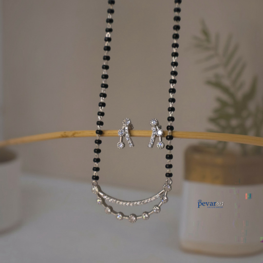 pevar925 oxidized silver double layer mangalsutra with black beads and matching stud earrings on a wooden display