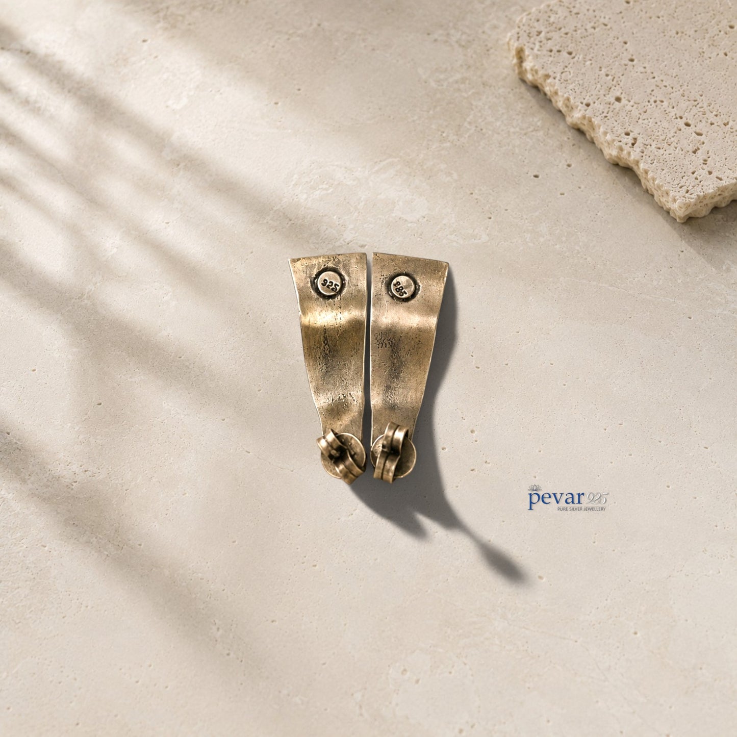 pevar925 oxidized 925 silver angled earrings with bird motifs and secure clasps on a textured stone surface