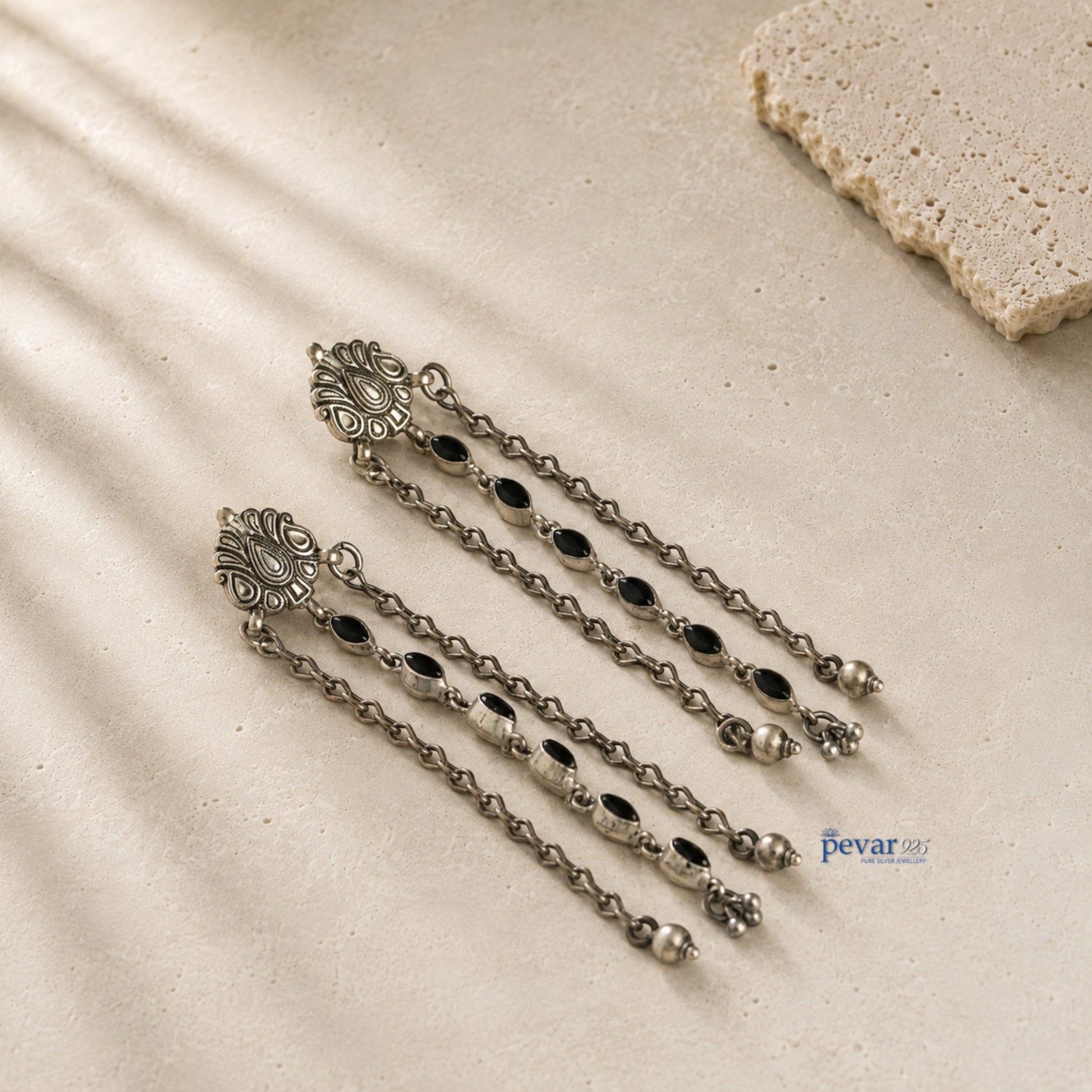 pevar925 oxidized 925 sterling silver dangler earrings with black oval stones, floral motifs, and hanging chains.