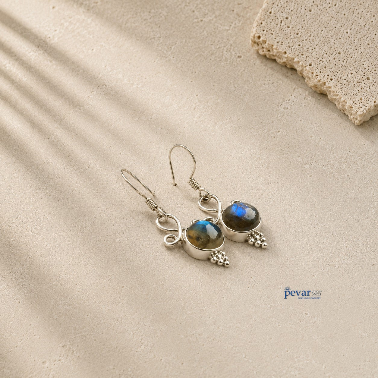 pevar925 oxidized 925 silver hook earrings featuring round blue crom stones with an antique finish on a textured surface