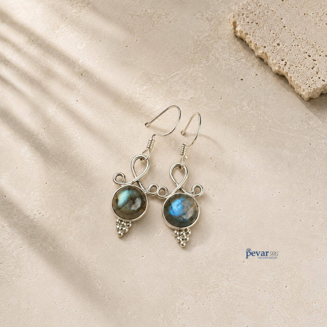 pevar925 oxidized 925 silver hook earrings featuring round blue crom stones with an antique finish on a textured surface