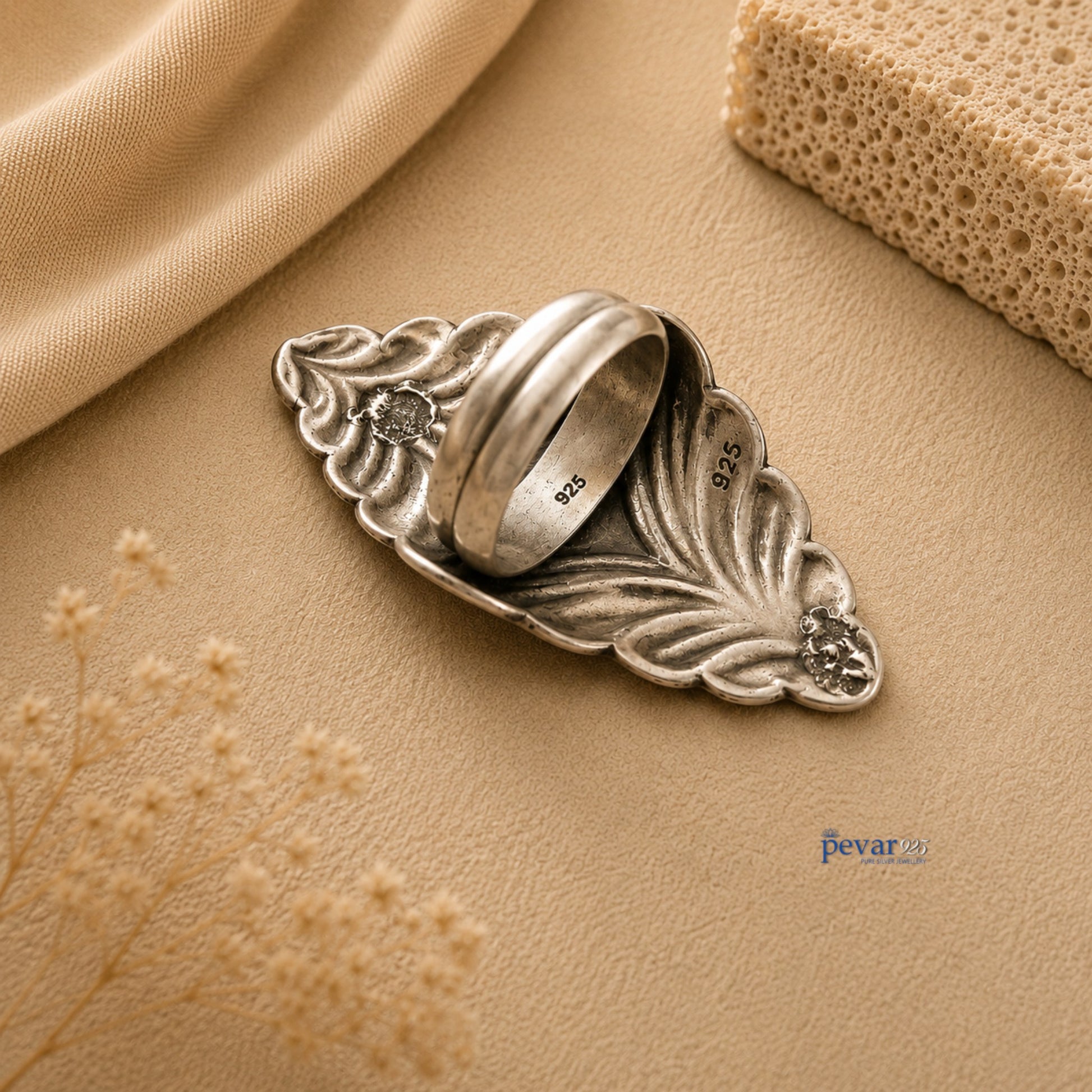 pevar925 oxidized silver adjustable ring with intricate diamond motif chitai engraving on a beige fabric background.