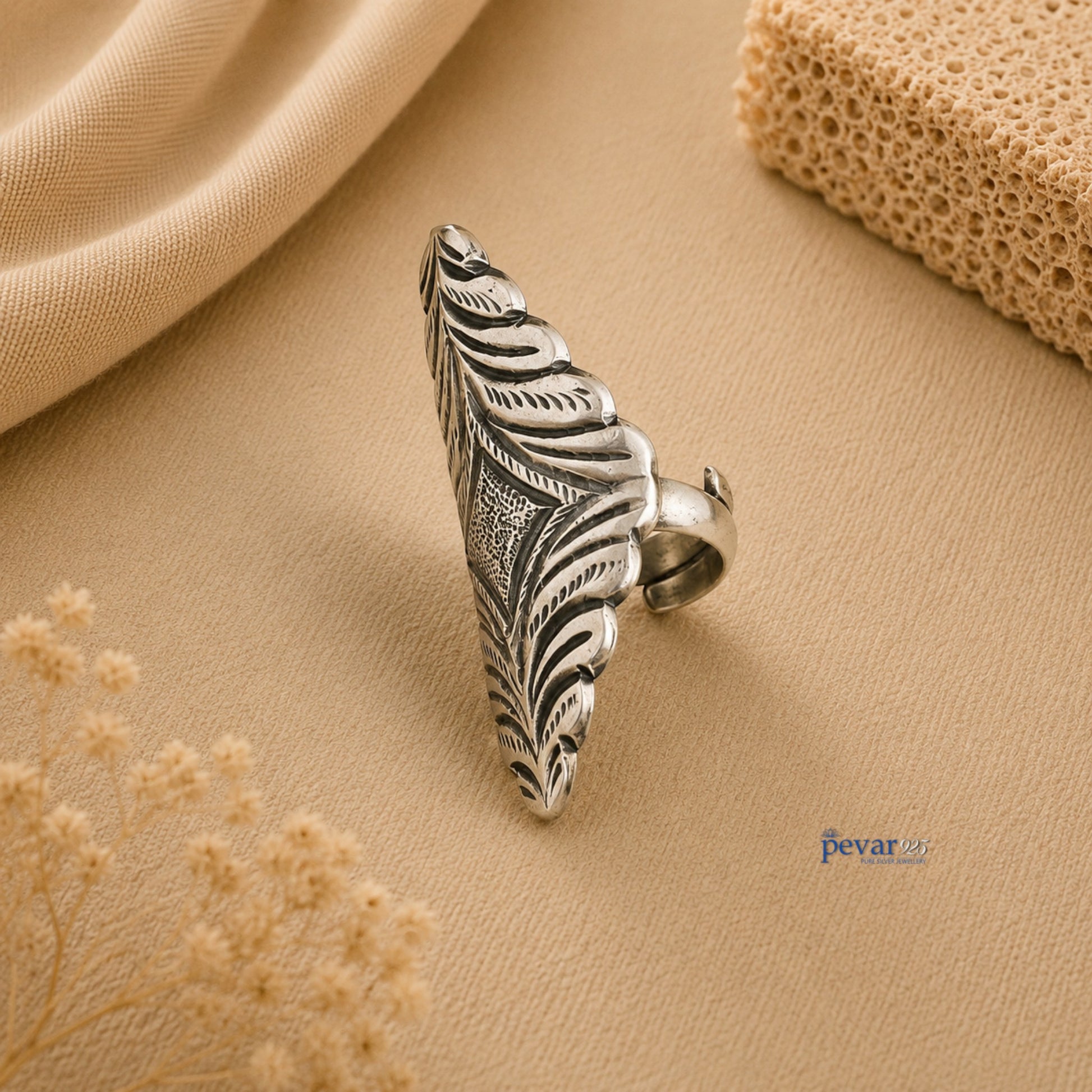 pevar925 oxidized silver adjustable ring with intricate diamond motif chitai engraving on a beige fabric background