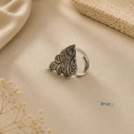 pevar925 oxidized silver crown ring with intricate chitai engraving on a beige textured background