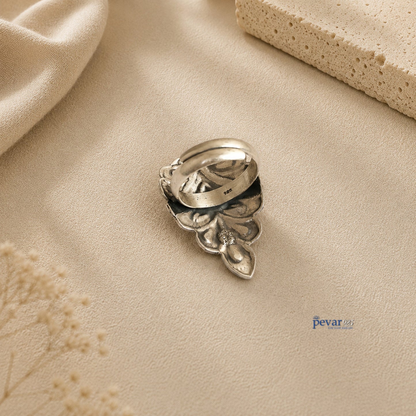 pevar925 oxidized silver crown ring with intricate chitai engraving and adjustable band on a neutral textured surface.