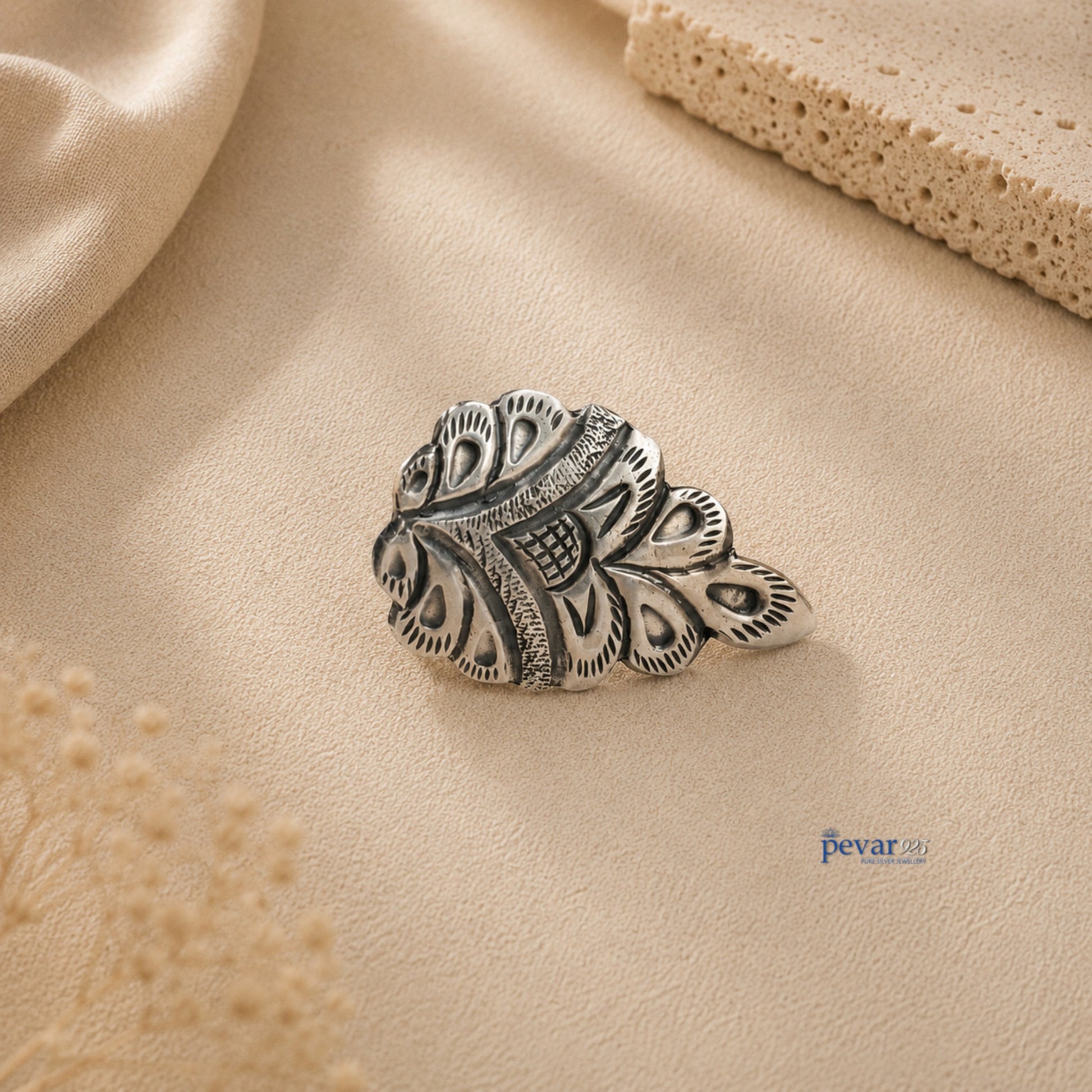 pevar925 oxidized silver crown ring with intricate chitai engraving on a neutral textured background