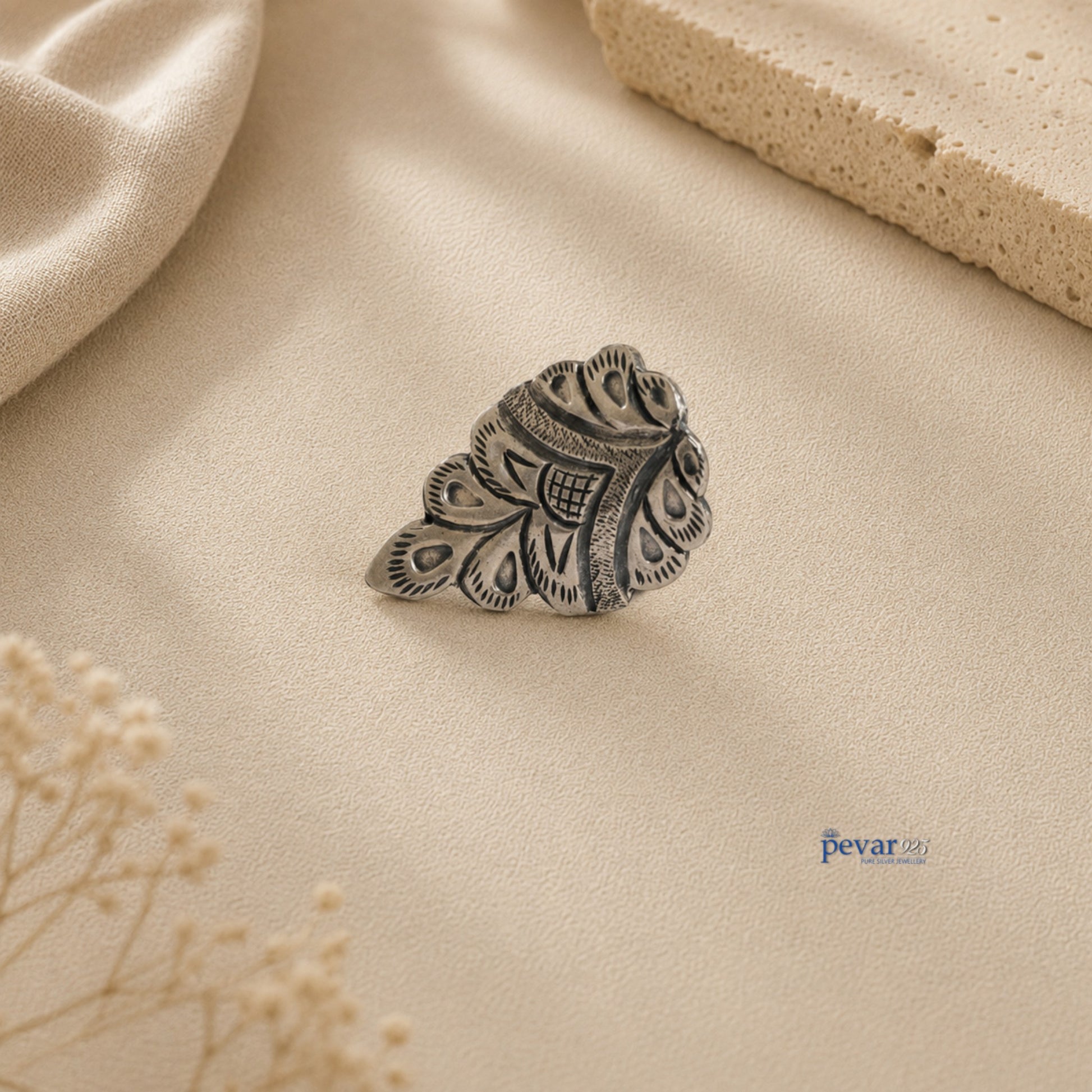 pevar925 oxidized silver crown ring with intricate chitai engraving on a neutral textured background