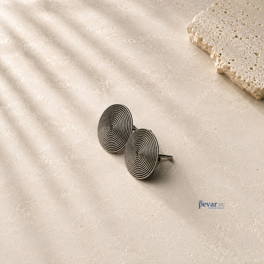 pevar925 oxidized 925 sterling silver stud earrings featuring a minimalist circular disc design with concentric lines.