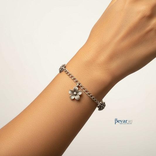 pevar925 oxidized 925 sterling silver chain bracelet featuring delicate floral charms on a woman's wrist