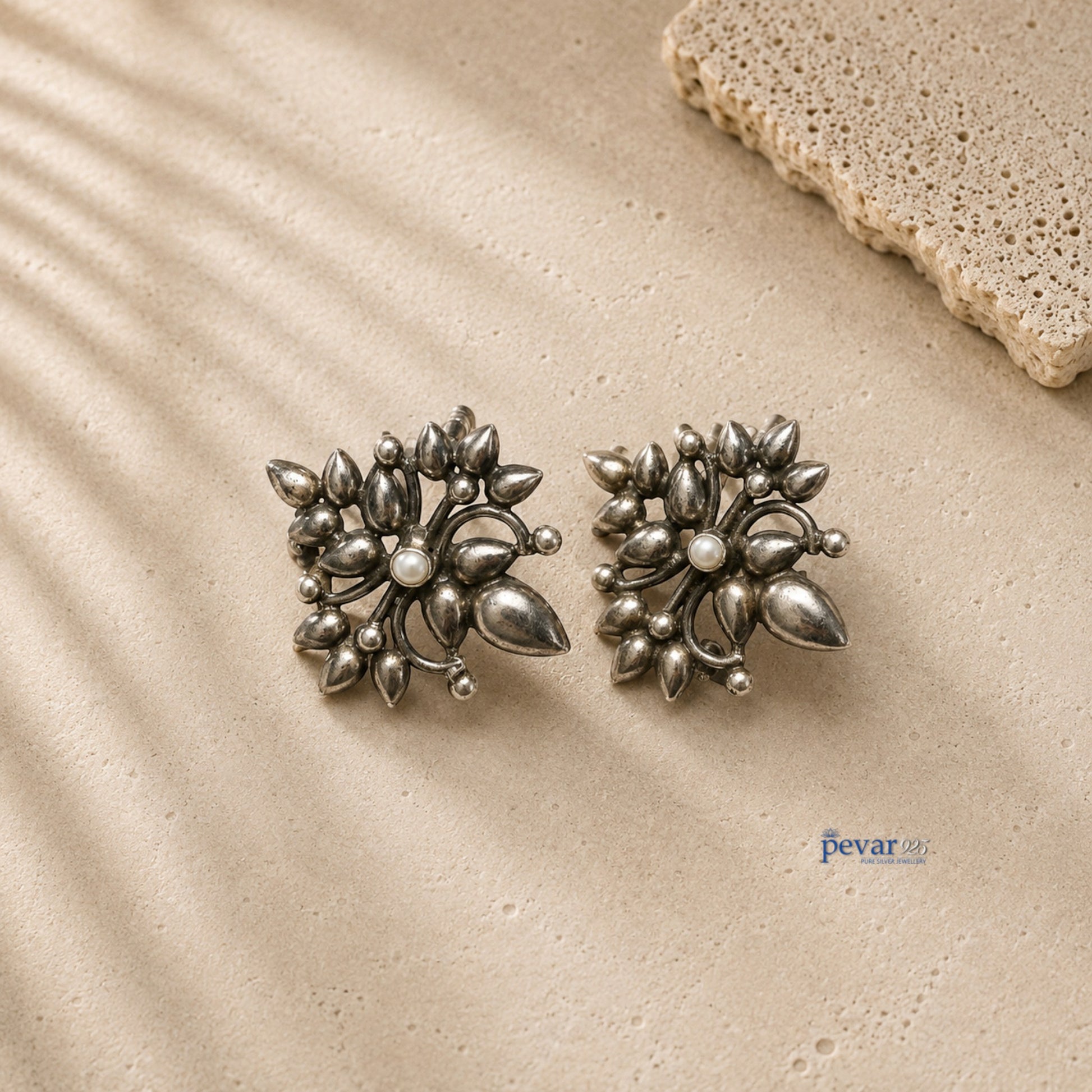 pevar925 oxidized 925 silver ear cuffs featuring large floral motifs with an antique finish on a textured surface