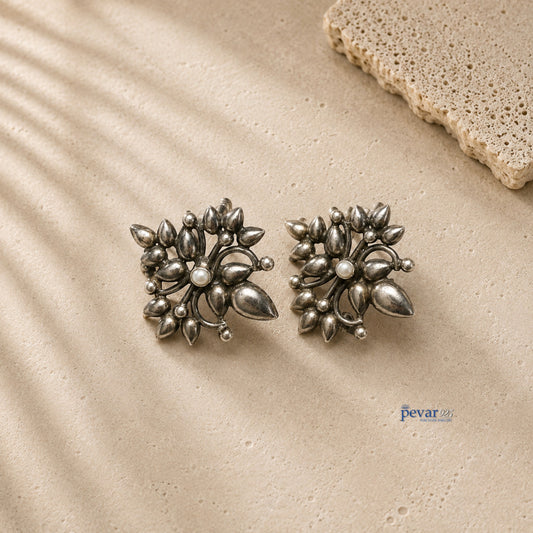pevar925 oxidized 925 silver ear cuffs featuring large floral motifs with an antique finish on a textured surface