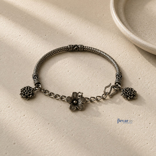 pevar925 oxidized 925 sterling silver kada bracelet featuring delicate floral charms and an adjustable chain clasp.