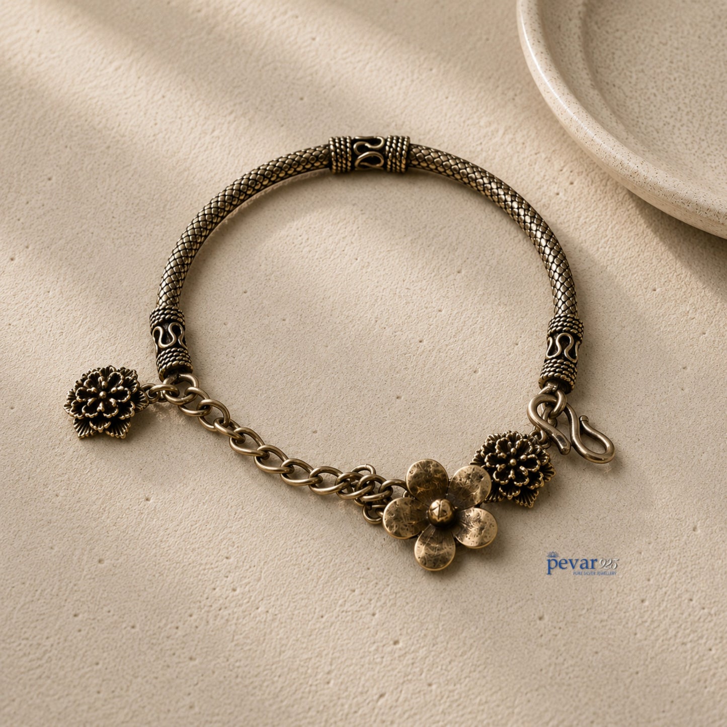 pevar925 oxidized 925 sterling silver kada bracelet featuring intricate floral charms and a vintage chain design.