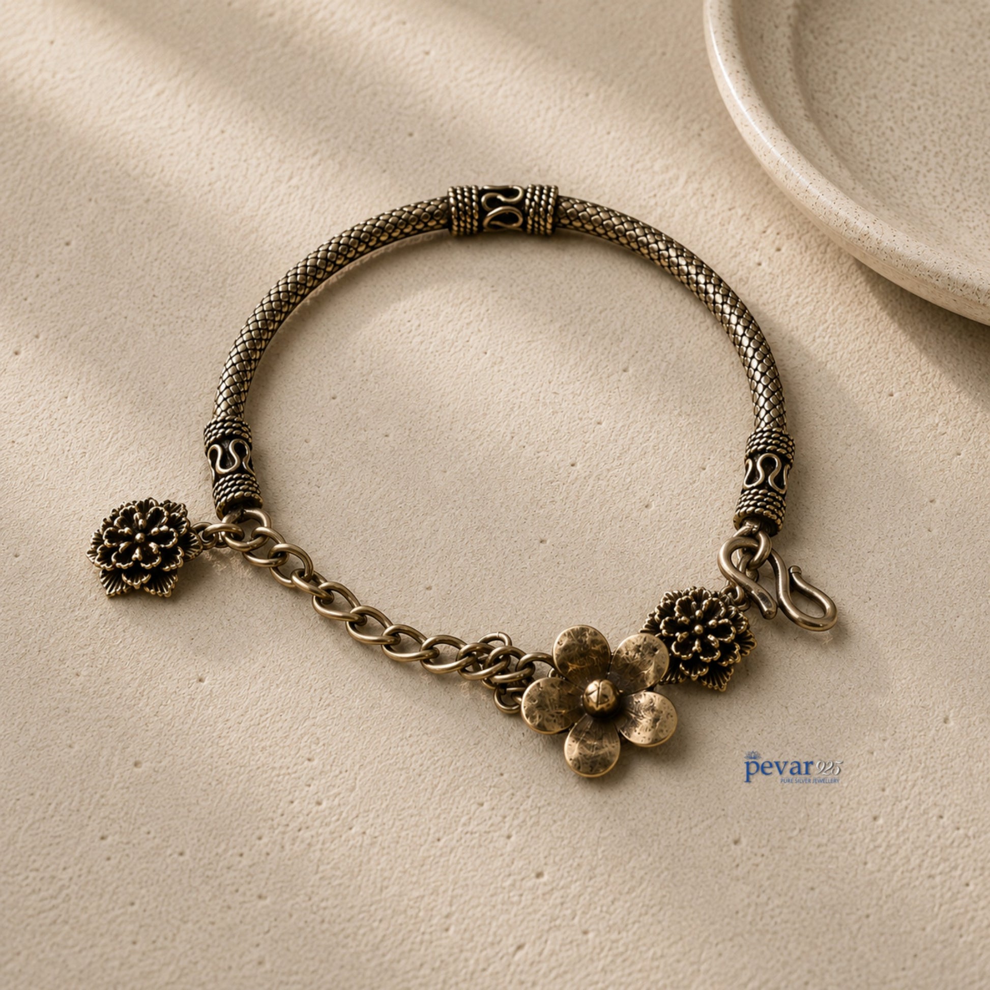 pevar925 oxidized 925 sterling silver kada bracelet featuring intricate floral charms and a vintage chain design.