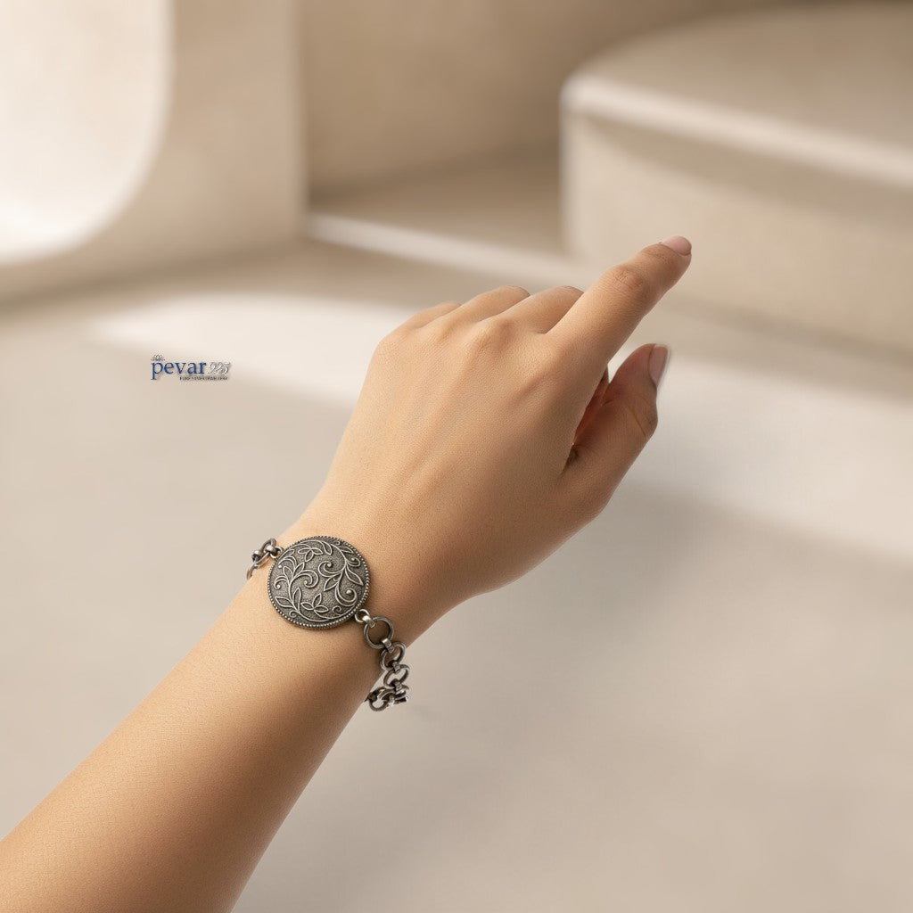 pevar925 oxidized 925 sterling silver bracelet featuring a round floral medallion with intricate vine engravings.