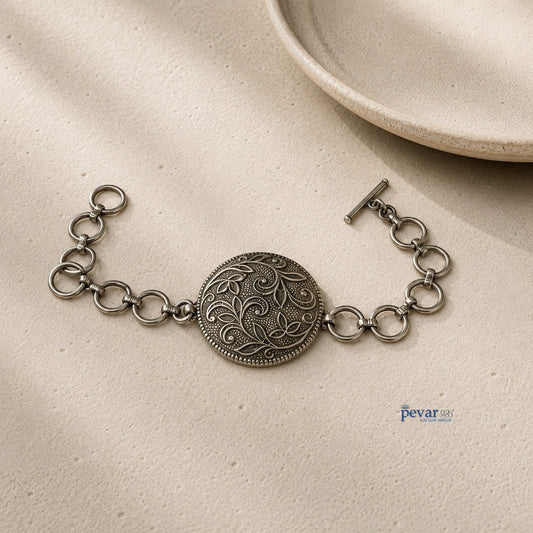 pevar925 oxidized 925 sterling silver bracelet featuring a round floral medallion with intricate vine engravings