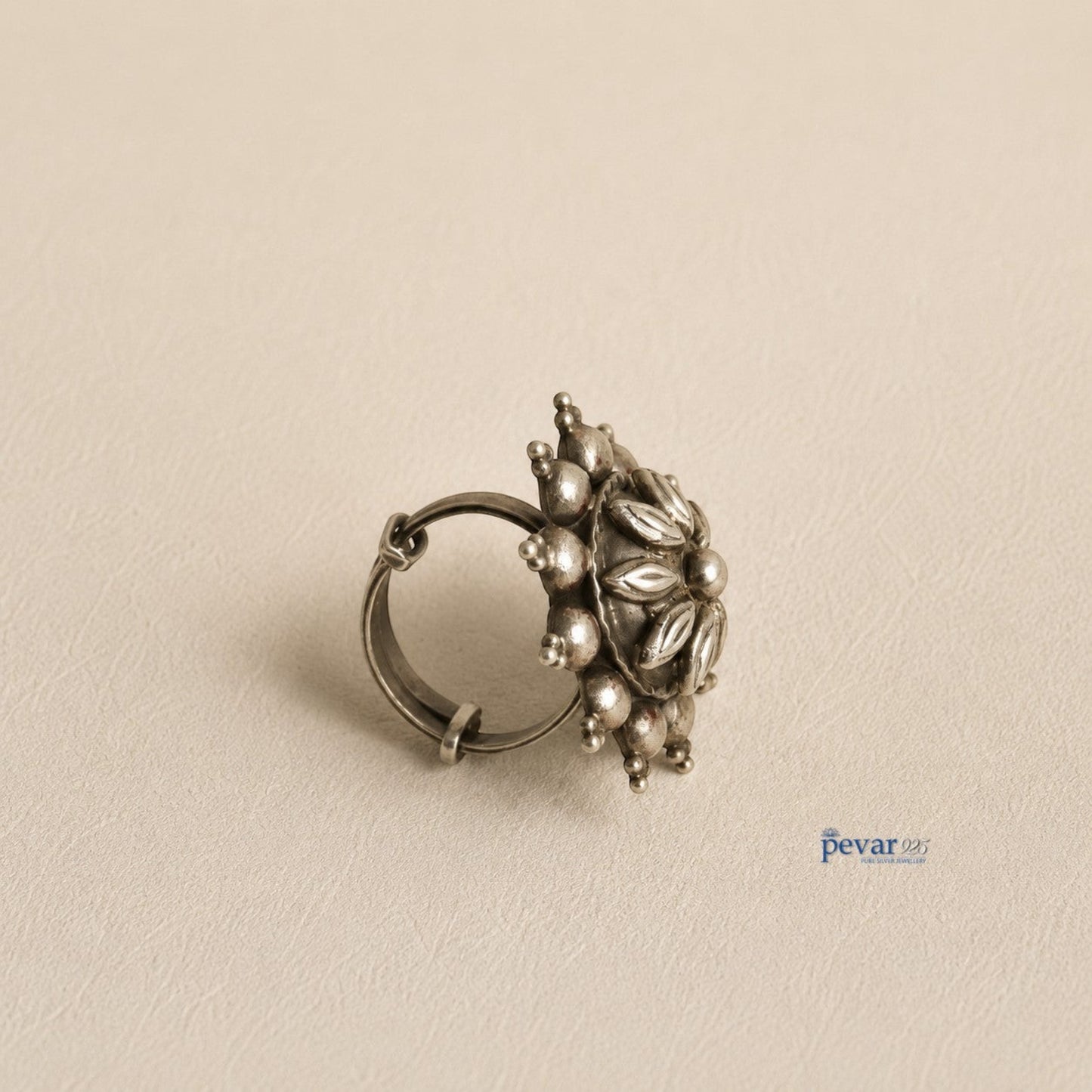 pevar925 oxidized sterling silver adjustable ring featuring a circular floral motif with petal engravings and bead detail