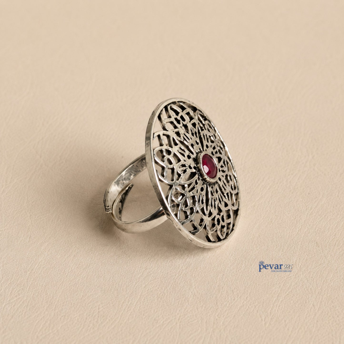 pevar925 oxidized sterling silver adjustable ring featuring a circular floral filigree motif with a central red stone