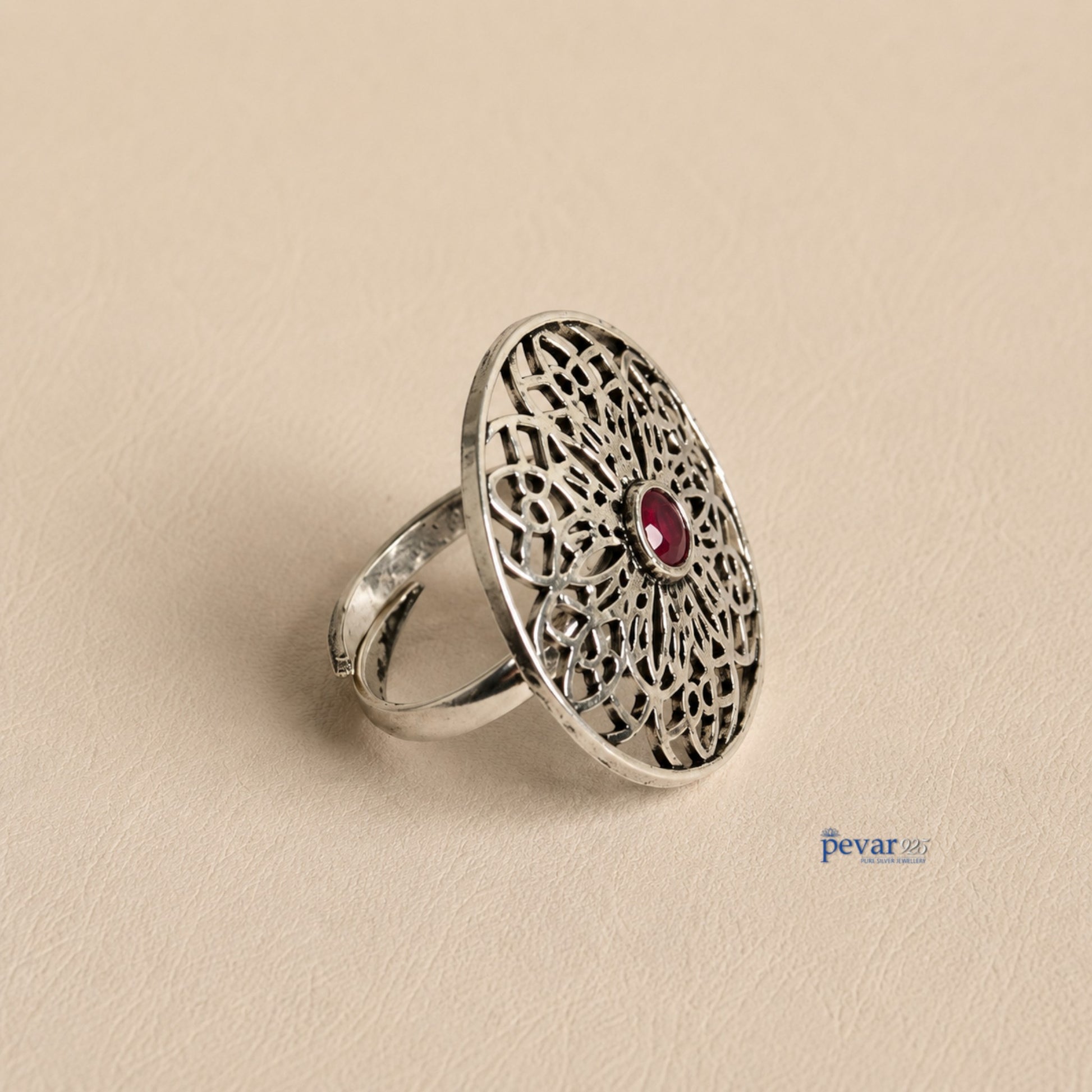 pevar925 oxidized sterling silver adjustable ring featuring a circular floral filigree motif with a central red stone