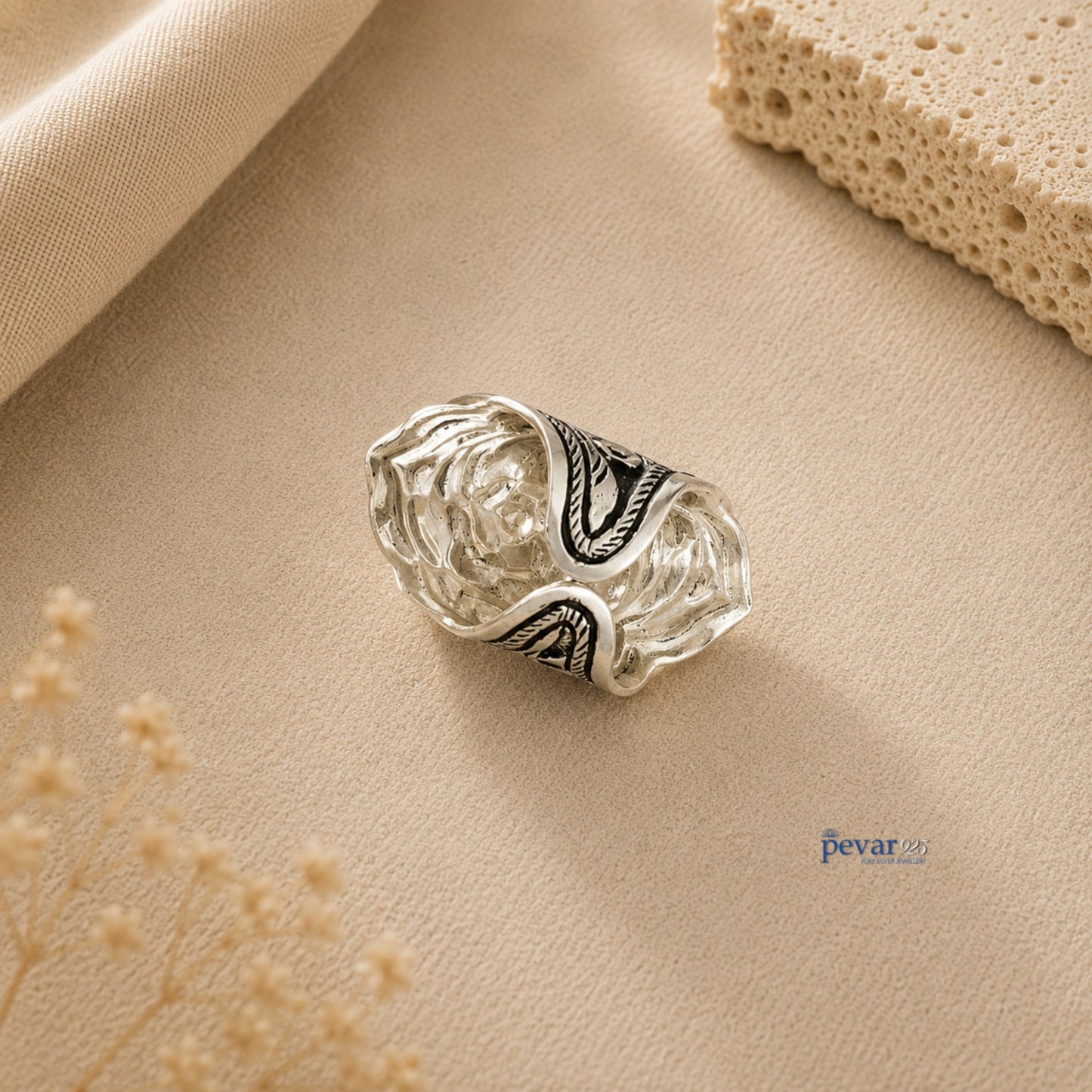 pevar925 oxidized silver adjustable ring featuring intricate floral chitai engraving on a textured beige background