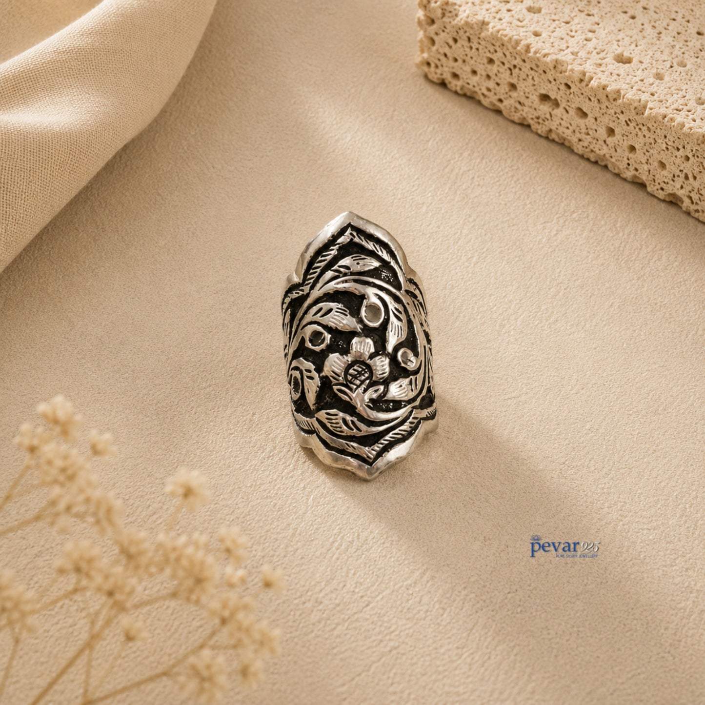 pevar925 oxidized silver adjustable ring featuring intricate floral and leaf chitai engraving on a neutral textured background