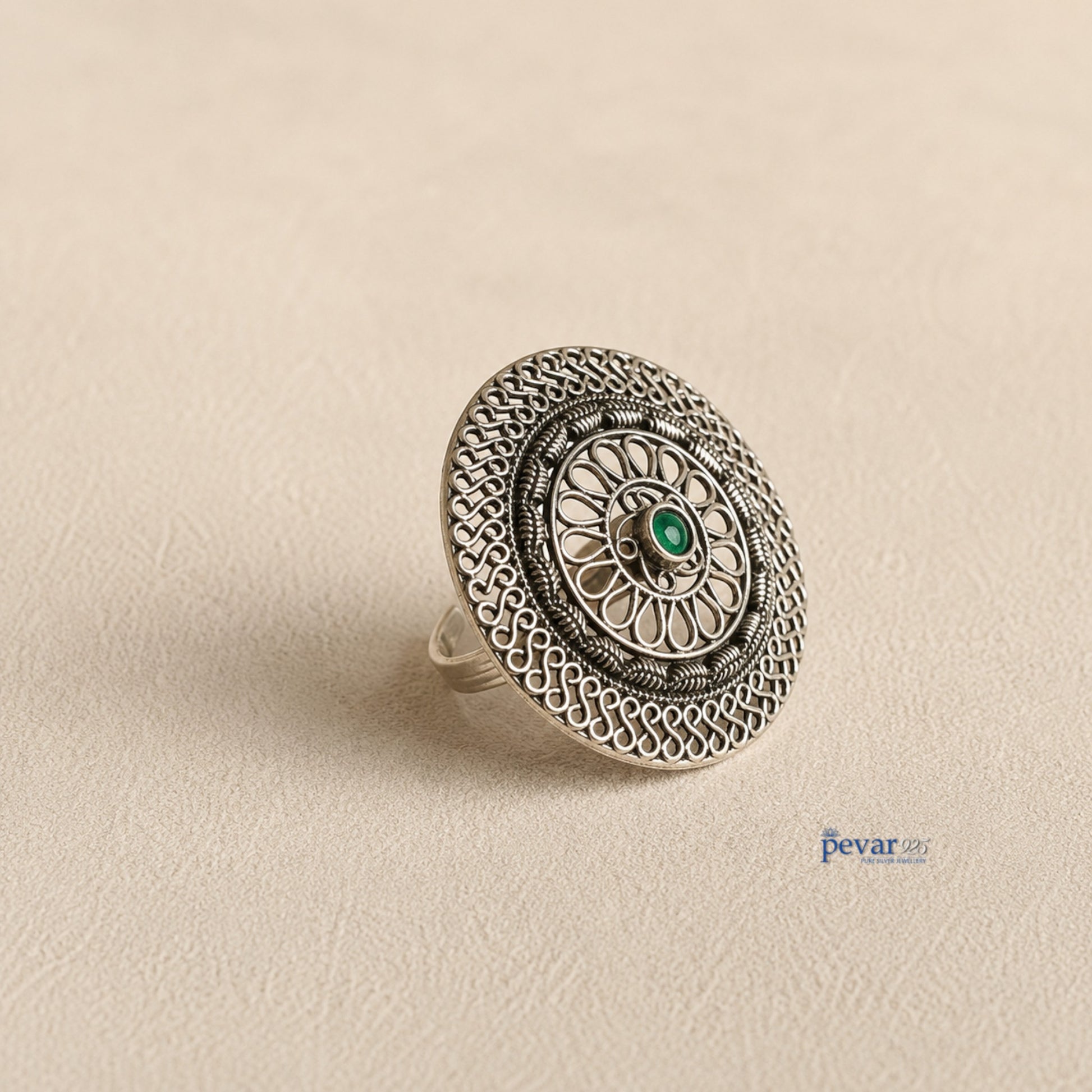 pevar925 oxidized sterling silver adjustable ring featuring a circular floral filigree motif and a central green stone