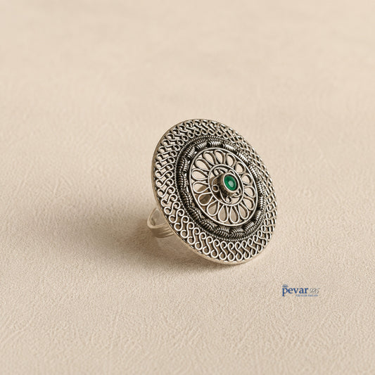 pevar925 oxidized sterling silver adjustable ring featuring a circular floral filigree motif and a central green stone