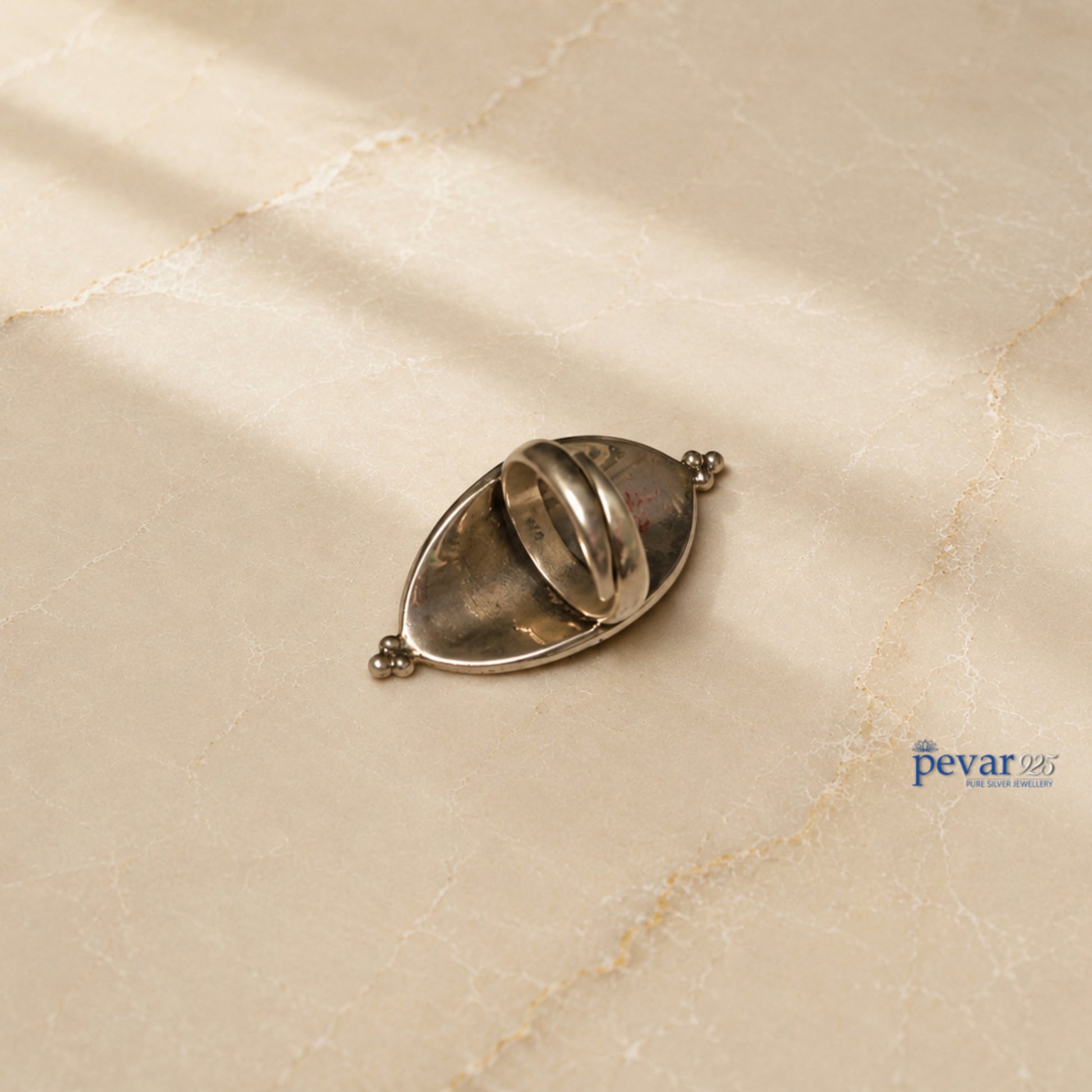 pevar925 handcrafted 925 oxidized silver adjustable ring with floral meenakari enamel and beaded border on marble surface