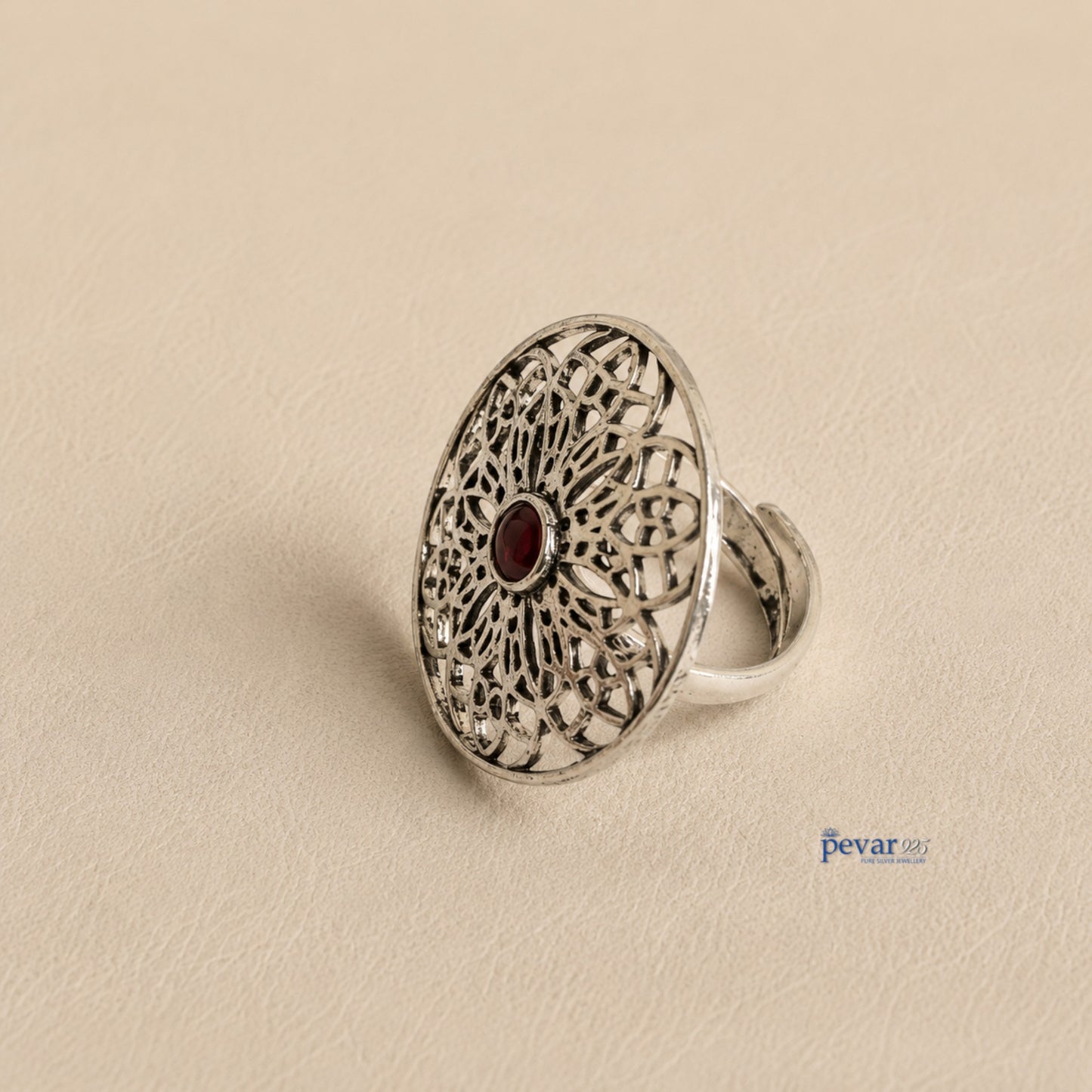 pevar925 oxidized sterling silver adjustable ring featuring a circular floral filigree motif with a central red stone