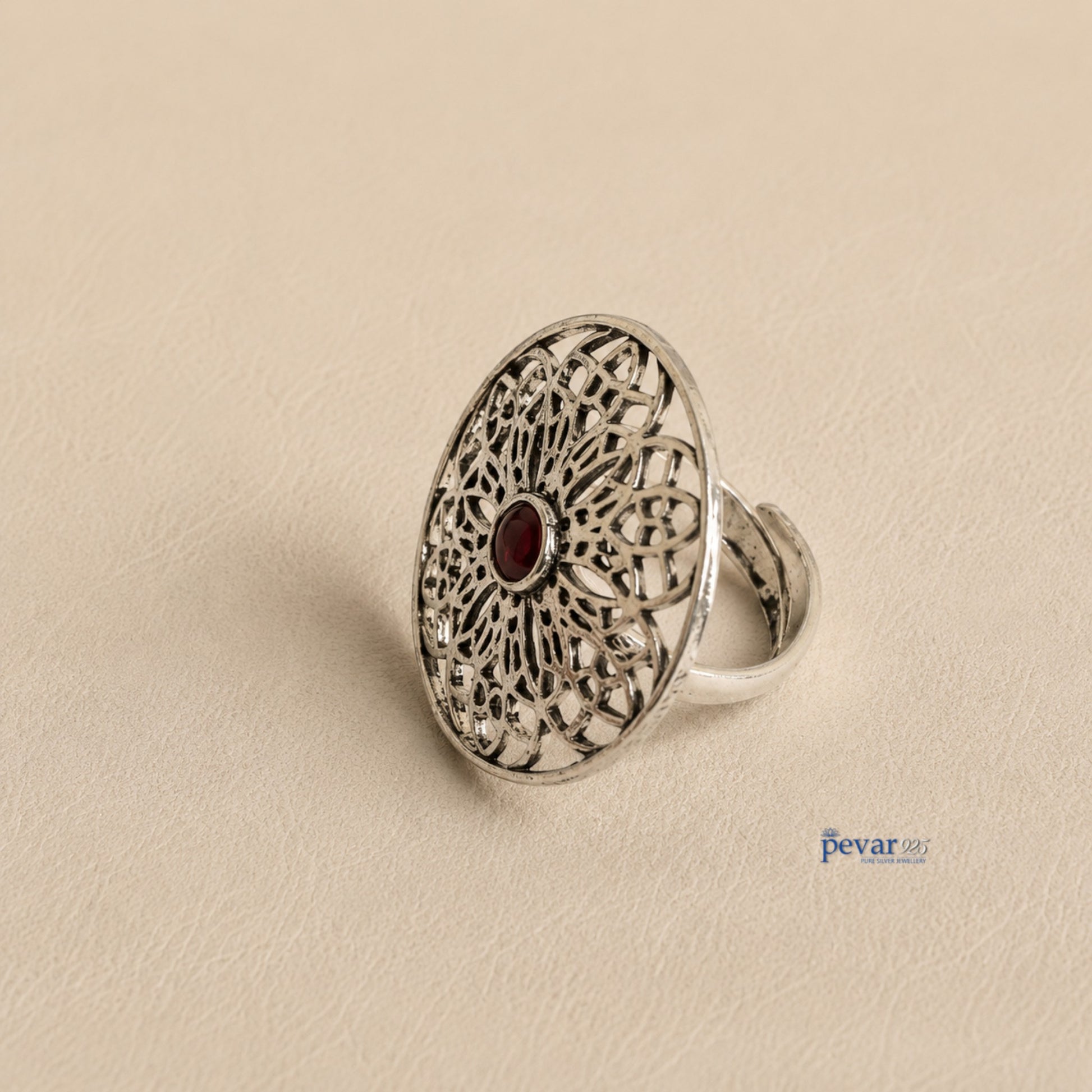 pevar925 oxidized sterling silver adjustable ring featuring a circular floral filigree motif with a central red stone