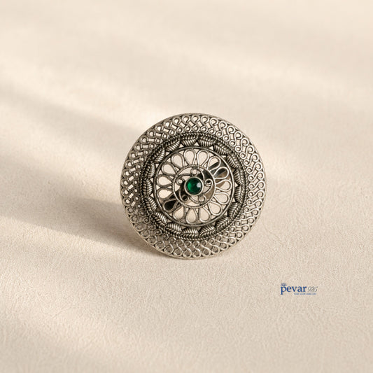pevar925 oxidized sterling silver adjustable ring featuring a circular floral filigree motif and a central green stone.