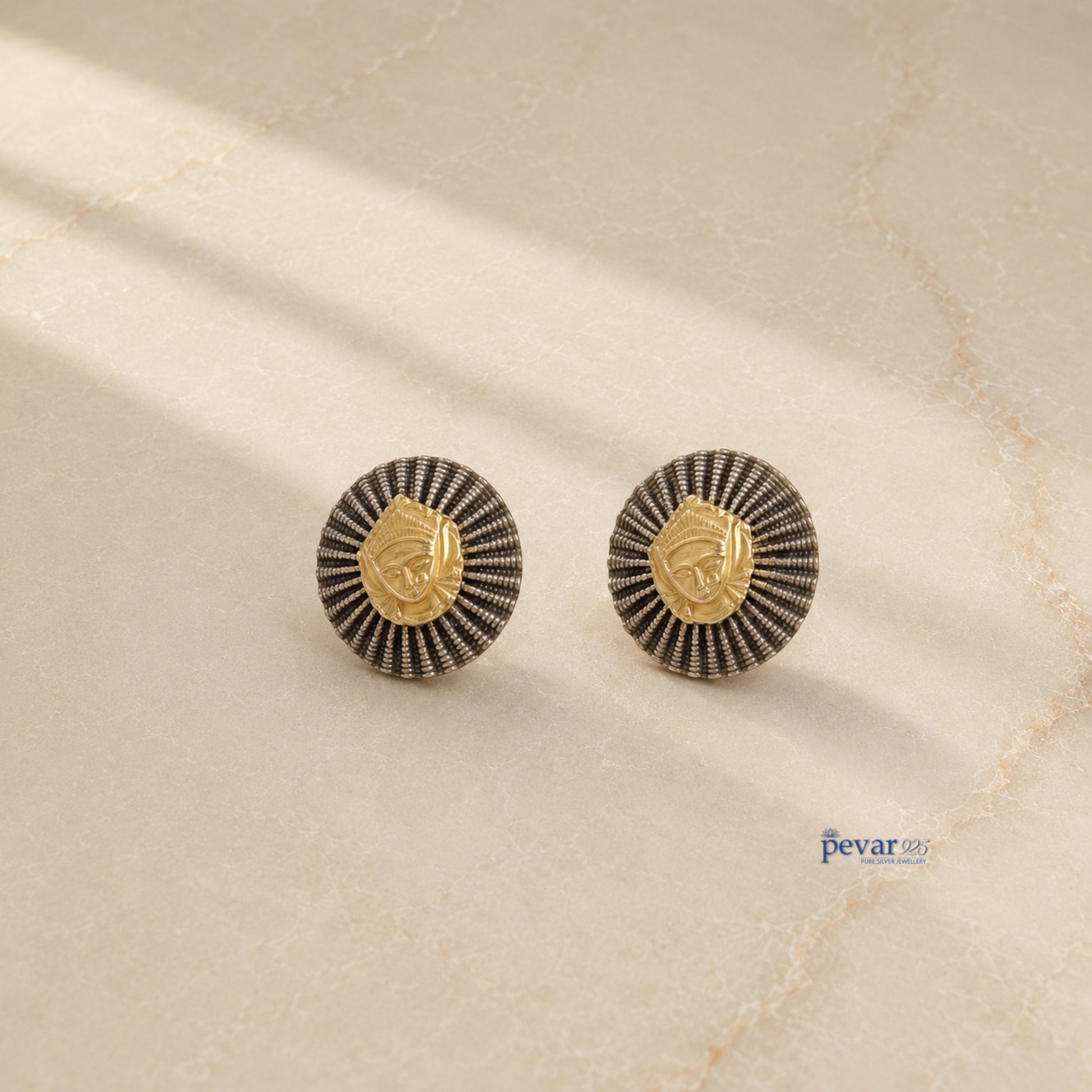 pevar925 oxidized silver temple earrings with a golden goddess face motif and radiating circular frame design.