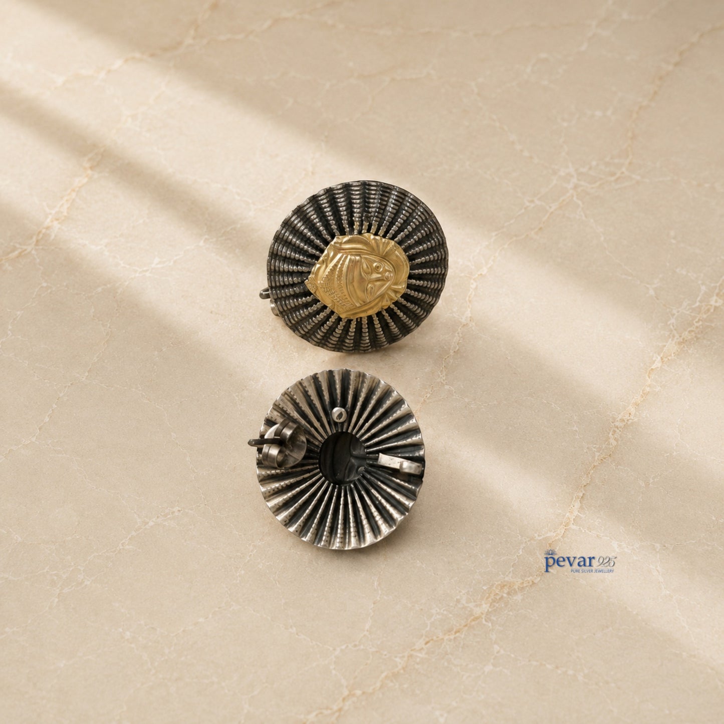 pevar925 oxidized silver statement earrings featuring a round ridged frame and a central golden goddess motif