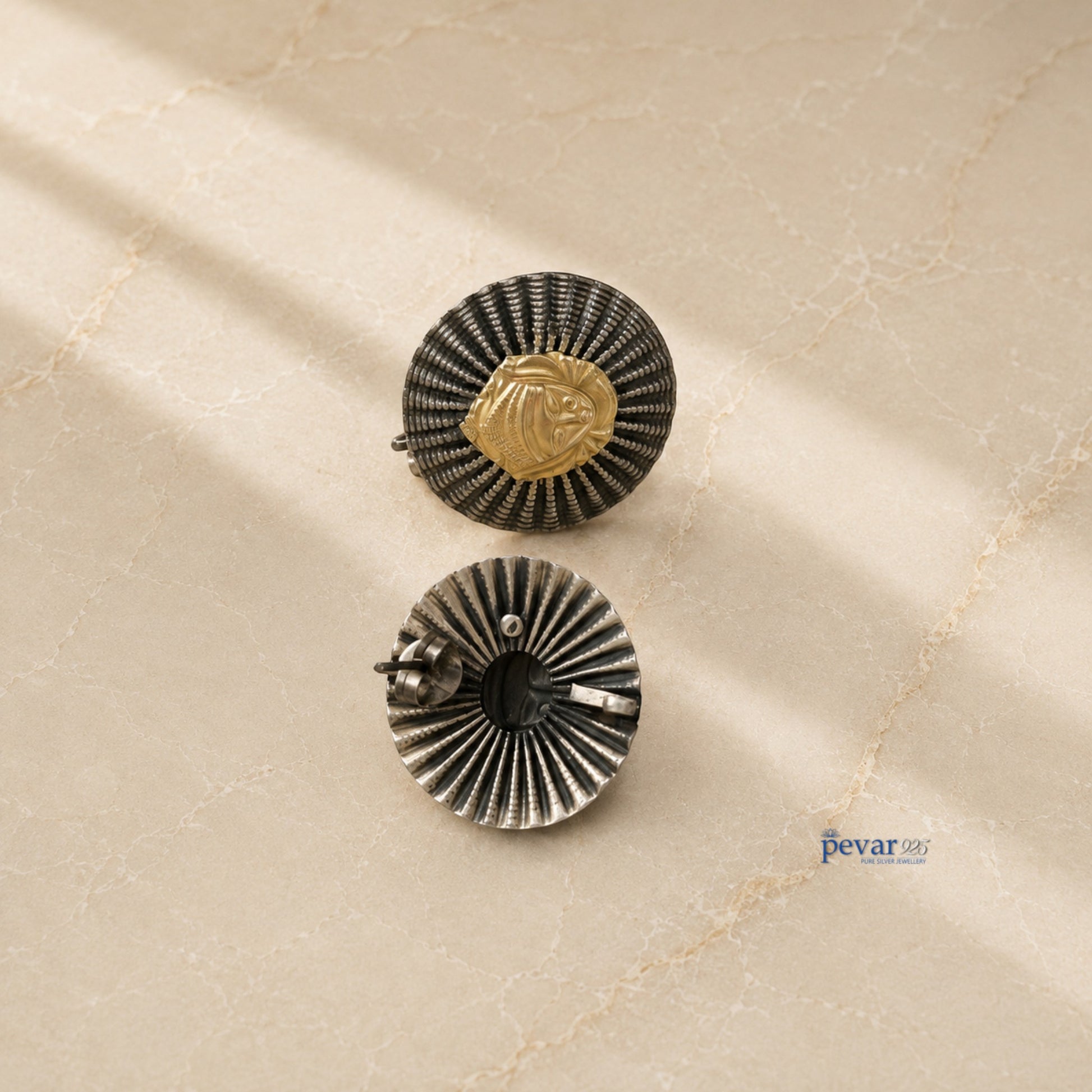 pevar925 oxidized silver statement earrings featuring a round ridged frame and a central golden goddess motif