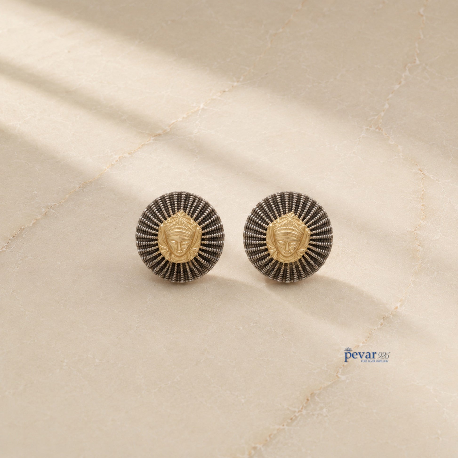 pevar925 oxidized silver round earrings featuring a central golden goddess motif and textured radiating ridges