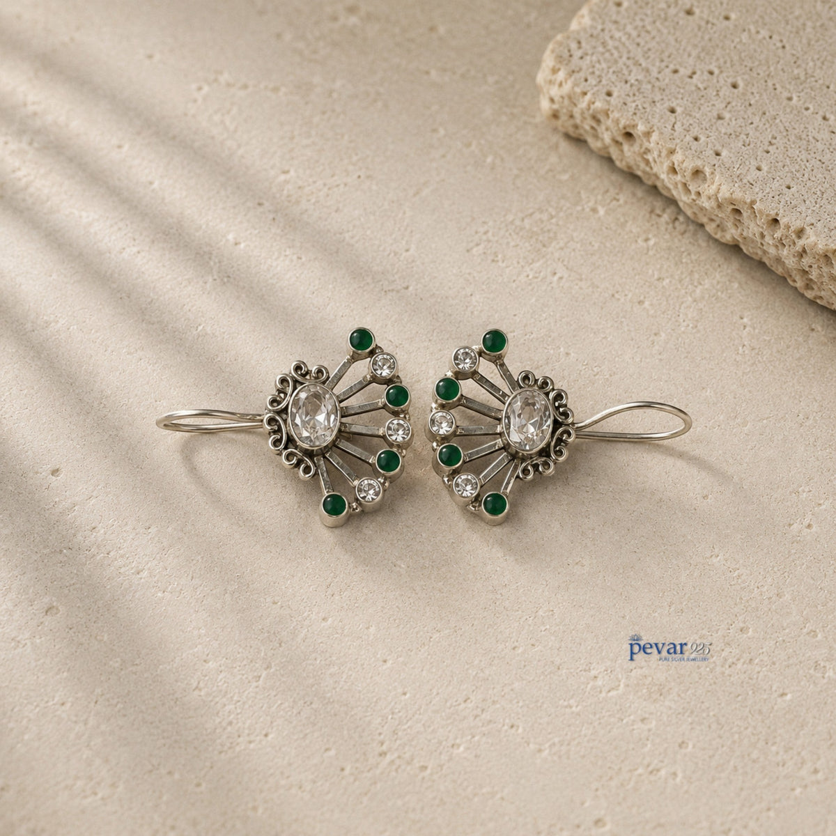pevar925 oxidized 925 silver fan earrings featuring vibrant green stones and clear crystals on a textured stone base.