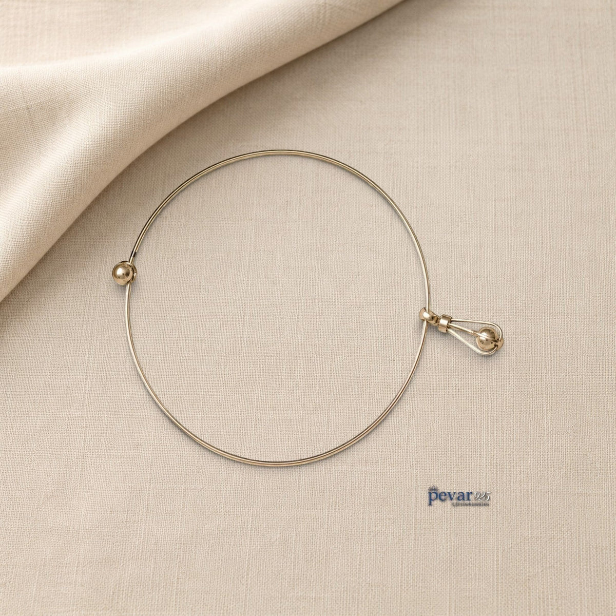 pevar925 oxidized silver hasli necklace featuring a minimalist circular band and an elongated cage pendant with a bead.