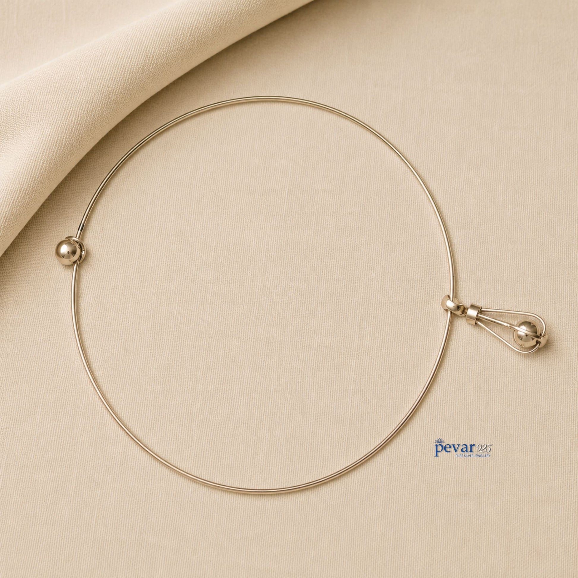 pevar925 oxidized silver hasli necklace featuring a minimalist circular band and an elongated cage pendant with a bead.
