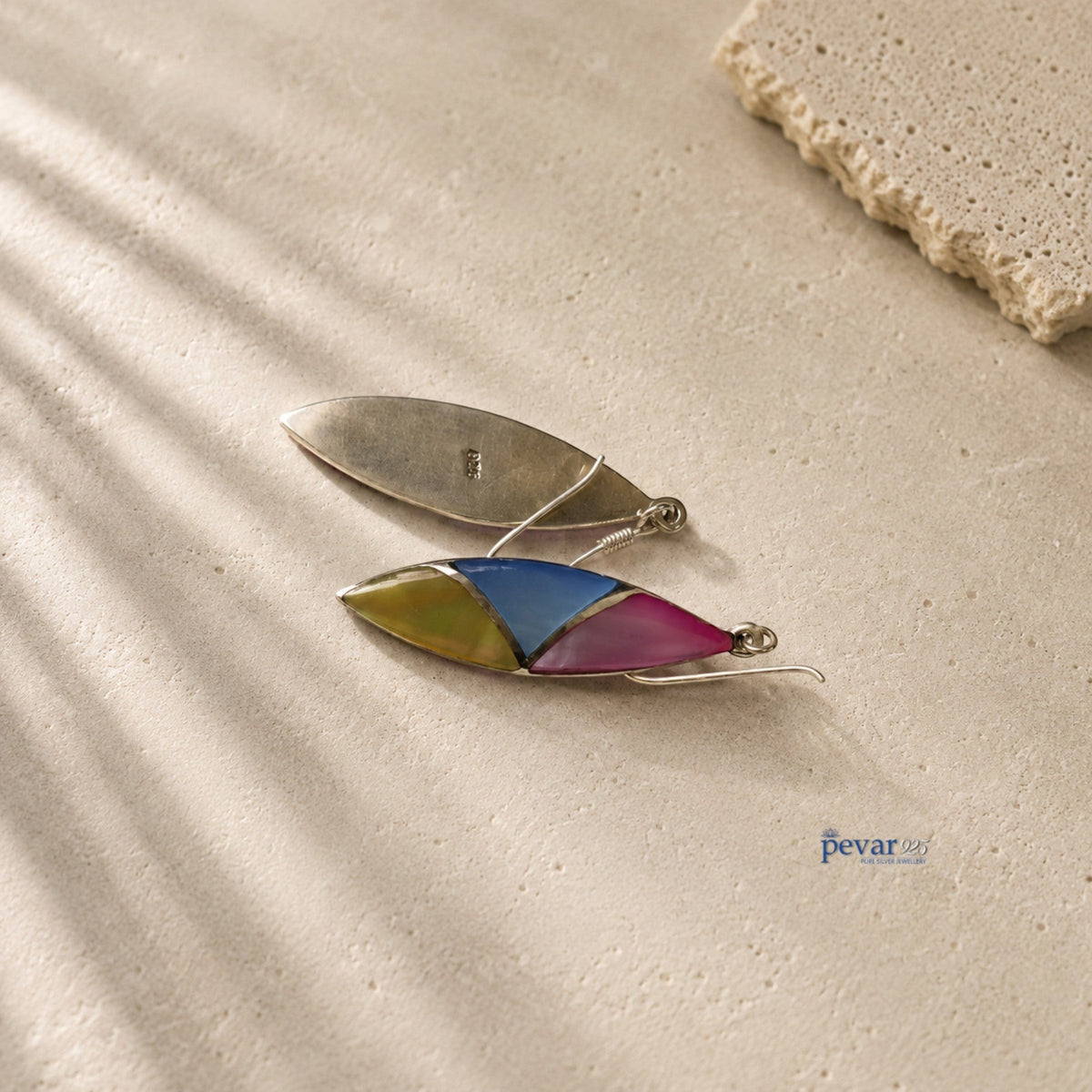 pevar925 oxidized silver hook earrings featuring tri-color leaf motifs on a textured stone surface.