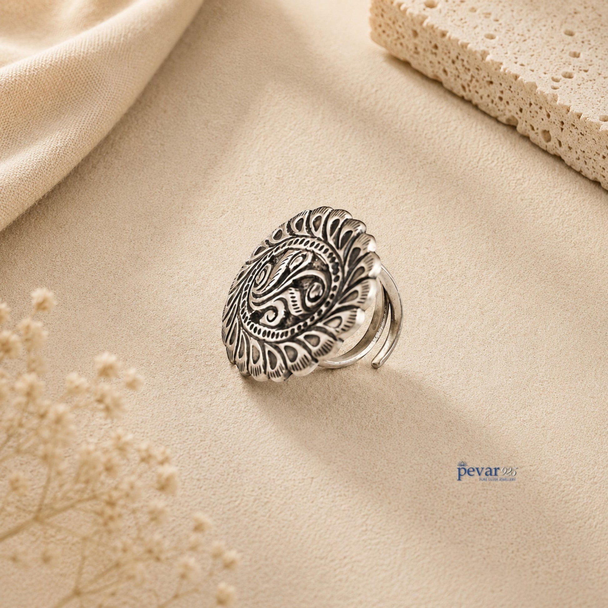 pevar925 oxidized silver adjustable ring featuring intricate oval leaf chitai engraving on a neutral textured surface